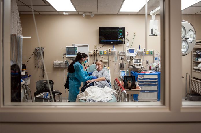 A COVID-19 patient is treated in the emergency room at Ocean Springs Hospital in Ocean Springs, Miss., on Aug. 14, 2021. (Rory Doyle/The New York Times)