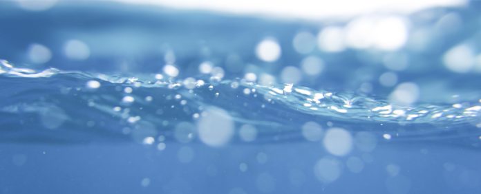 blue sea Water splash with bubbles of air,shot from underwater
