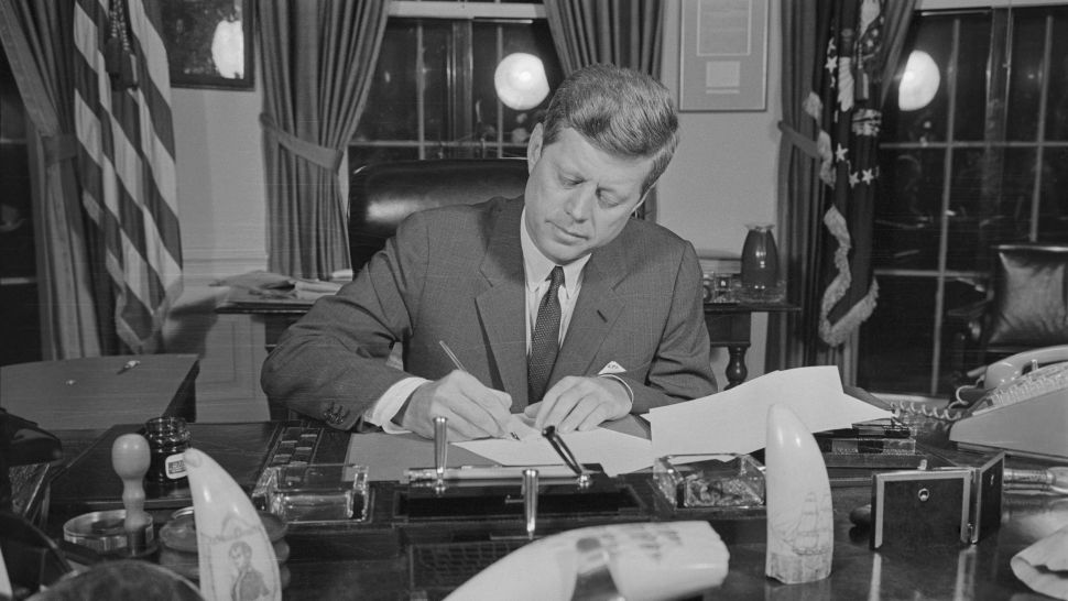 Presidente John F. Kennedy assinando a ordem de bloqueio durante a crise dos mísseis cubanos. (Crédito da imagem: Bettmann/Getty Images)